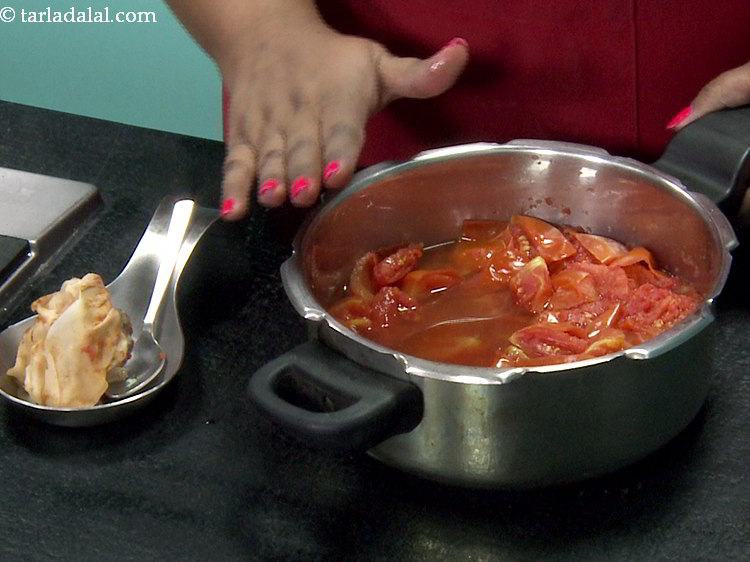 Step 14 – Allow the steam to escape before opening the lid, remove the potli from the tomato …