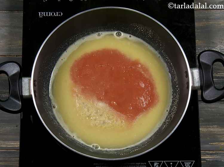 Step 16 – Now add the fresh tomato pulp to the dal once it gets a boil.