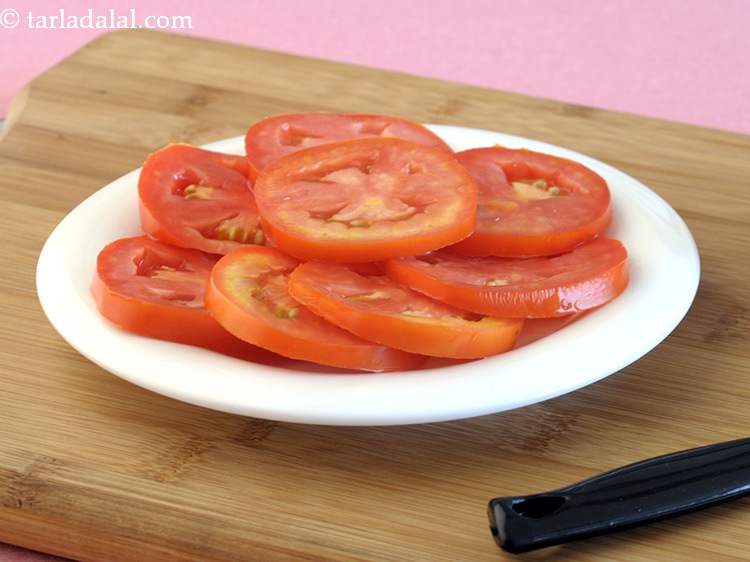 Step 20 – Place 4 <a href="https://www.tarladalal.com/glossary-tomato-slices-1823i">tomato slices</a>.