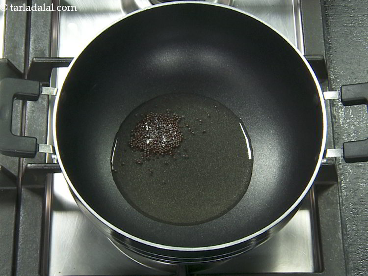 Step 5 – Once the oil is hot, add mustard seeds.