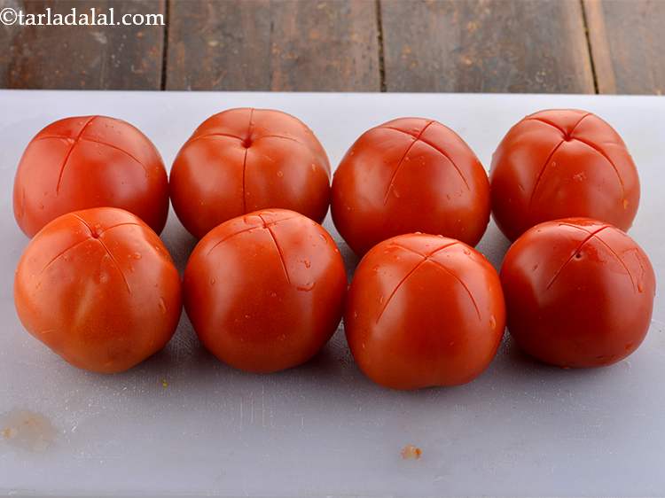 Step 5 – Make a criss-cross cuts at the base of each tomato. This helps in easy peeling …