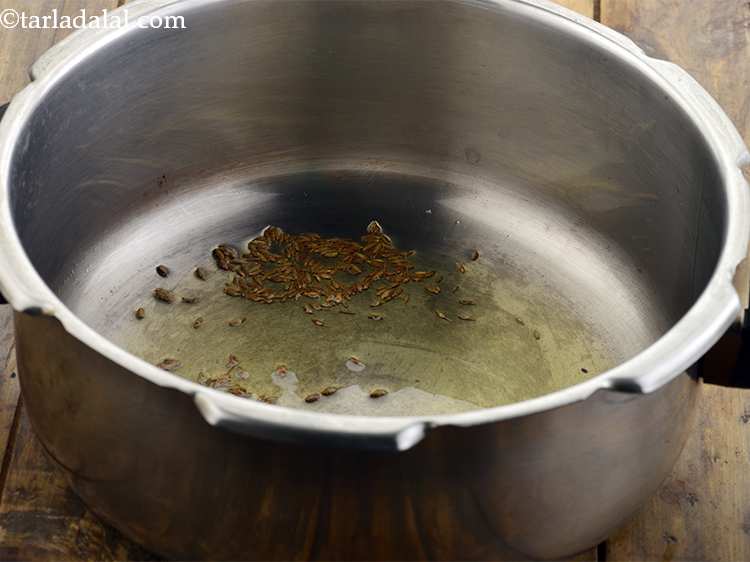 Step 5 – Heat the ghee in a pressure cooker. Once the ghee is hot, add the cumin …