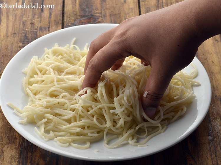 Step 10 – Toss them lightly with your hands. Oil prevents the noodles from sticking to each other.