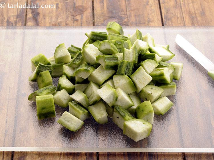 Step 3 – Place the turai on a chopping board and cut into cubes. Keep aside.
