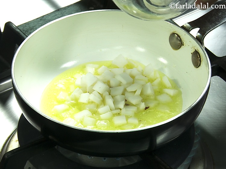 Step 12 – Once the ghee is nice hot and melted, add the coconut. We have used fresh …