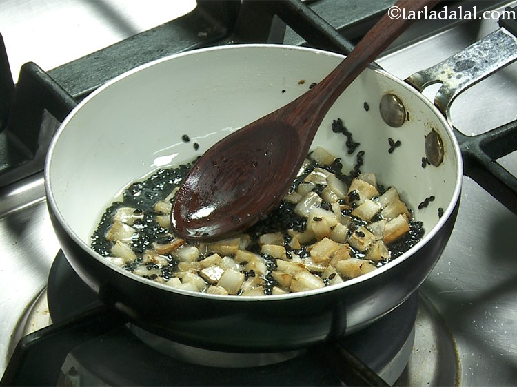 Step 14 – Add the black sesame seeds mix well and switch off the flame and allow it …