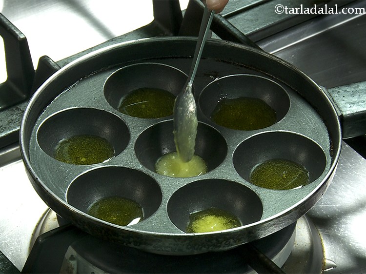 Step 20 – To make <strong>unni appam</strong>, heat 1 tsp ghee in each appe mould of an appe …