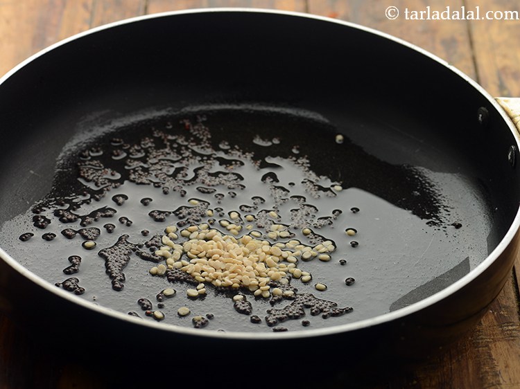 Step 5 – Once the seeds crackle, add urad dal.