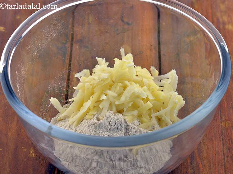 Step 6 – Add the peeled and grated raw potatoes. Potatoes act as binding agent for your<strong> Upvaas …