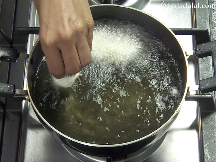 Step 21 – Drop spoonful of the mixture into hot oil using your fingers.