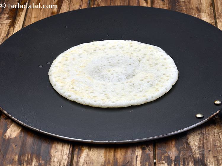 Step 14 – Cook the uttapam on both sides till light brown in color. Press it lightly while …