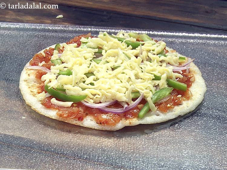 Step 8 – Finally, sprinkle 2 tbsp of cheese evenly over it. We are using mozzarella cheese for …