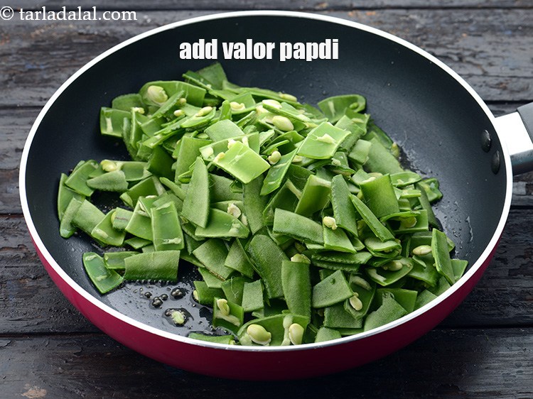 Step 23 – Add 2 1/2 cups&nbsp;<a href="https://www.tarladalal.com/glossary-chopped-valor-papdi-2450i">chopped valor papdi</a>.&nbsp;