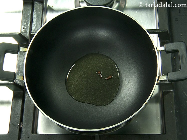 Step 20 – Once the oil is hot, add the cloves.