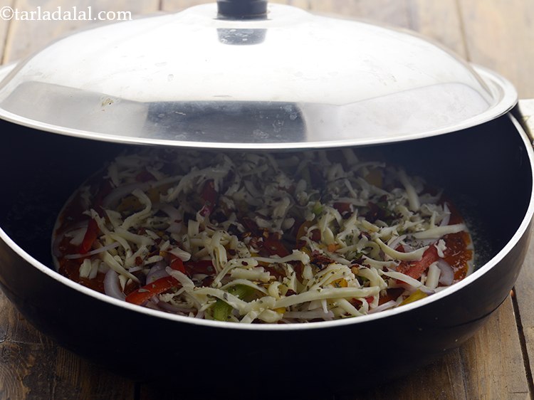 Step 62 – Place the prepared pizza on the pan and cover and cook it for 5-7 mins …