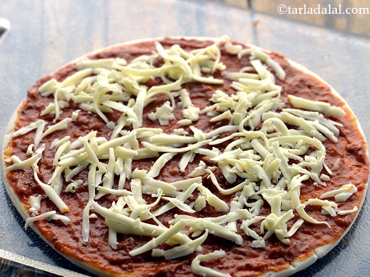 Step 54 – Evenly spread 1/4 cup of grated pizza cheese.