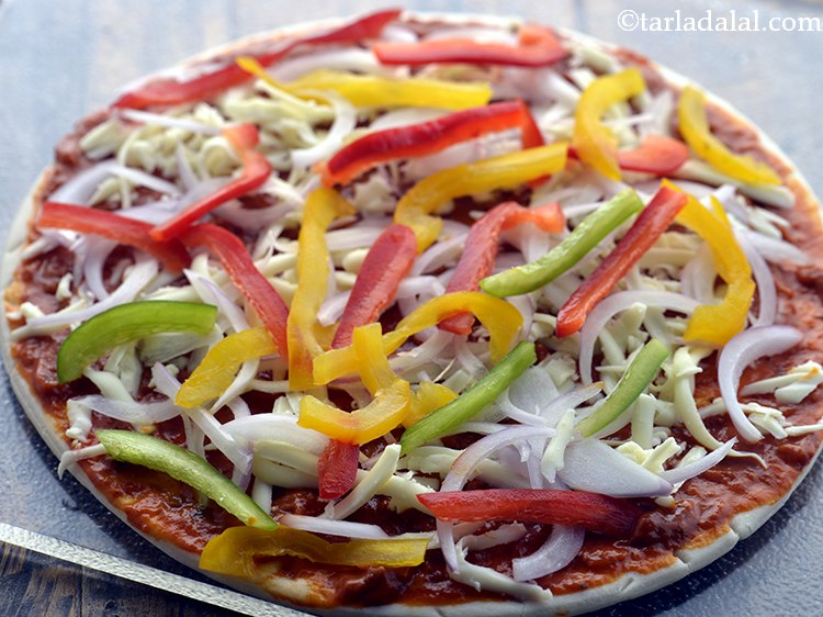 Step 56 – Next, arrange &frac14; cup sliced capsicum evenly over it.