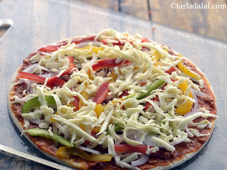 Step 57 – Sprinkle &frac14; cup of grated cheese. We are using mozzarella cheese for this vegetable pizza …