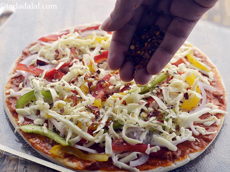 Step 58 – Sprinkle a little oregano and chilli flakes evenly over it. This is optional as you …