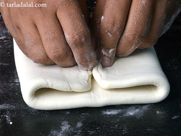 Step 16 – Now bring both the sides together in the centre but do not overlap them.