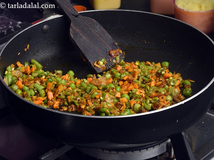 Step 4 – Add the green peas, carrot, french beans and 1 tbsp of water, mix well and …