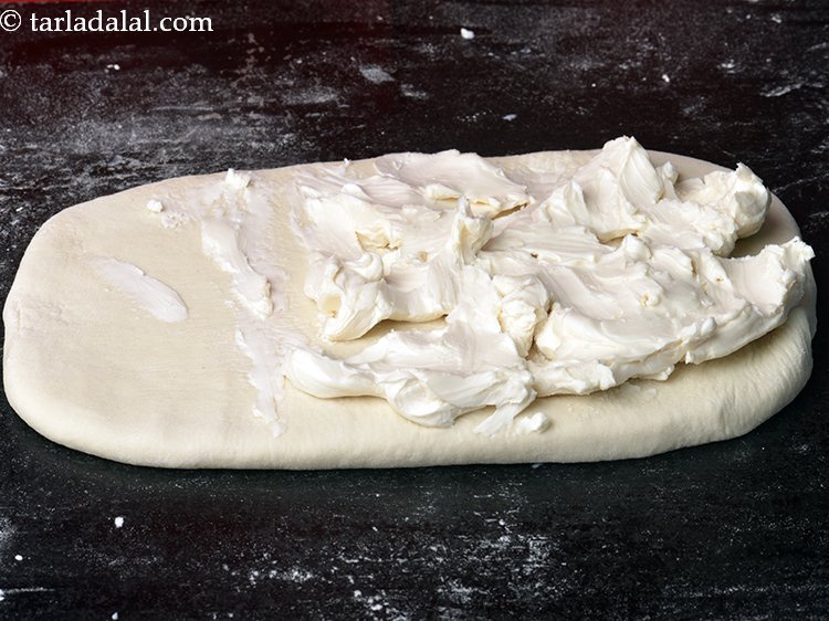 Step 9 – Spread the margarine on 2/3 portion of the rectangle with your hands.