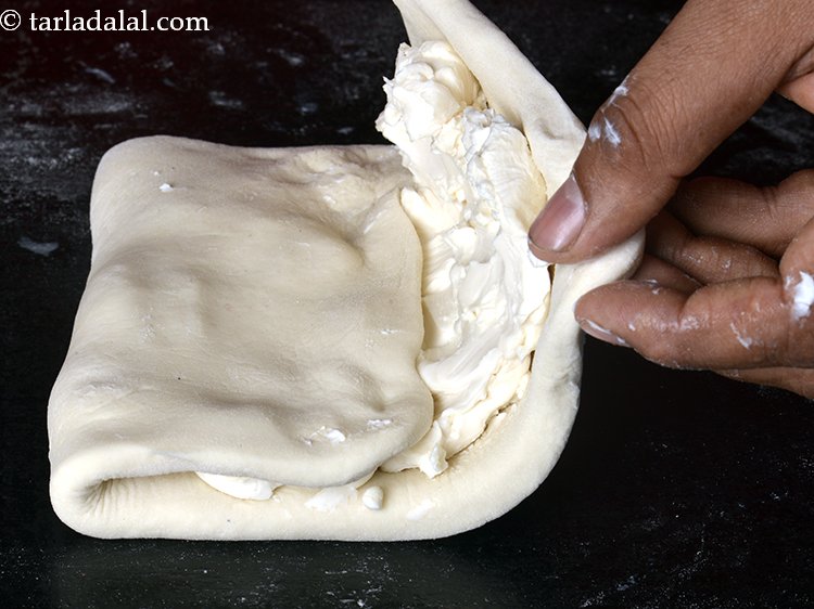 Step 10 – Fold the portion with no margarine side till the centre and then fold the margarine …
