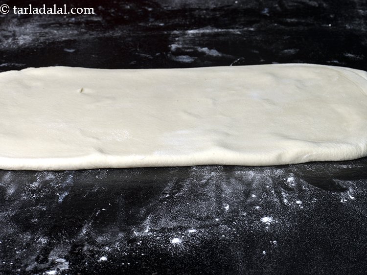 Step 15 – Dust the flat surface once again with a little plain flour. Place the dough on …