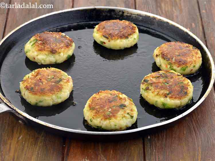 Step 12 – Cook from both the sides till they turn golden brown in colour. Press them a …