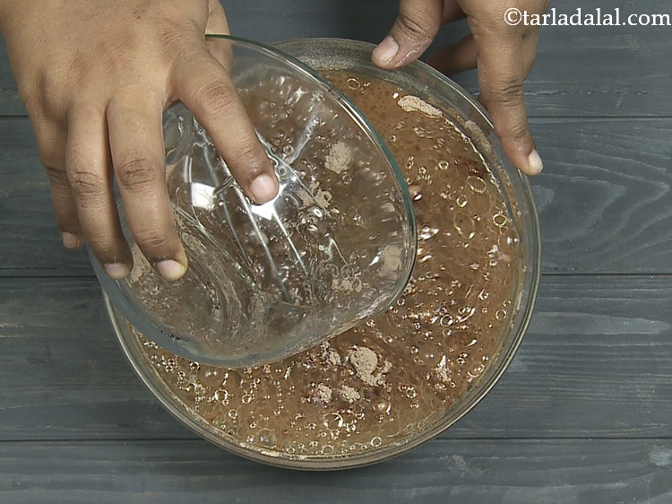 Step 12 – Add the prepared water-oil mixture to <strong>Eggless</strong>&nbsp;<strong>Vegan Chocolate Cake</strong>.