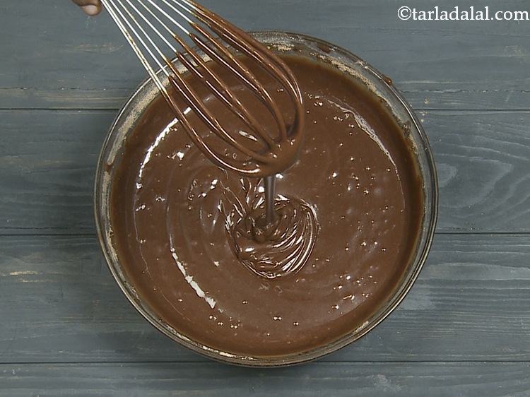 Step 13 – Mix well using a whisk and our batter for the <strong>Eggless</strong>&nbsp;<strong>Vegan Chocolate Cake</strong>&nbsp;is ready!