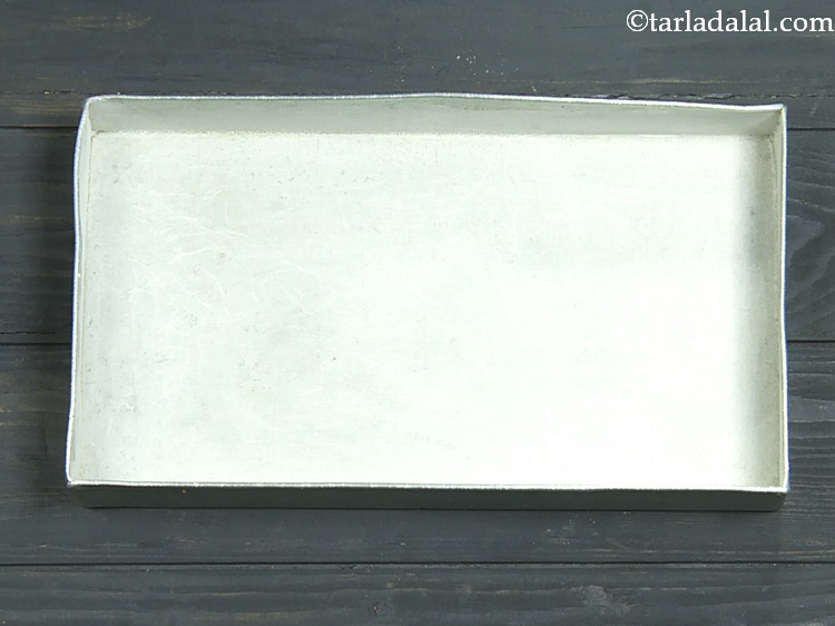 Step 14 – For baking the&nbsp;<strong>Vegan Chocolate Cake</strong>, grease a rectangle aluminium cake tin of 250 mm. (10&rdquo;) …