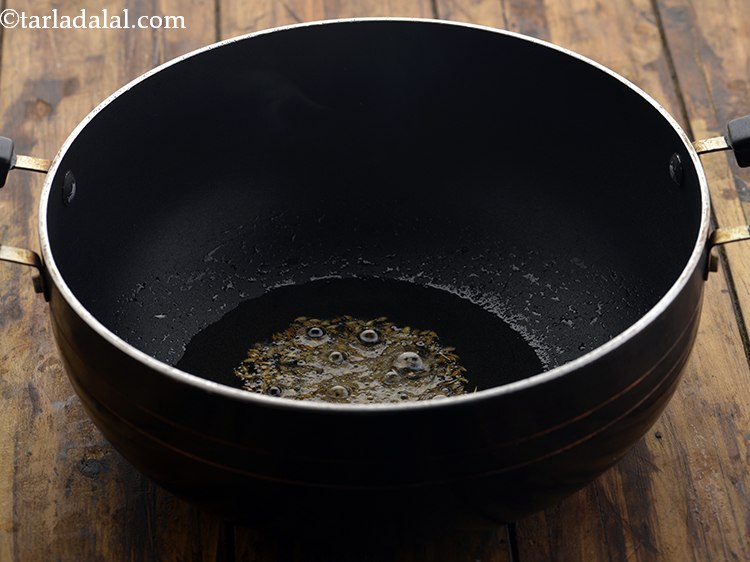 Step 11 – When the oil is hot, add the cumin seeds.