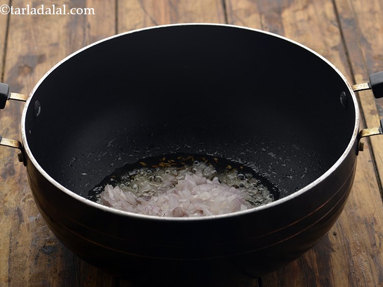 Step 12 – When the seeds crackle, add the onions.