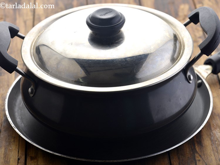 Step 39 – Cover it with a lid and place the handi on a non-stick tava (griddle).