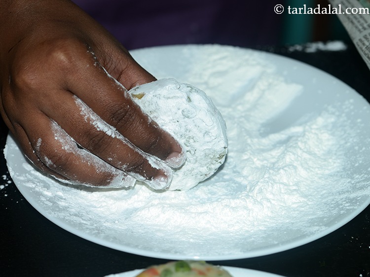 Step 24 – Roll the cutlets in cornflour till they are evenly coated from all the sides. If …