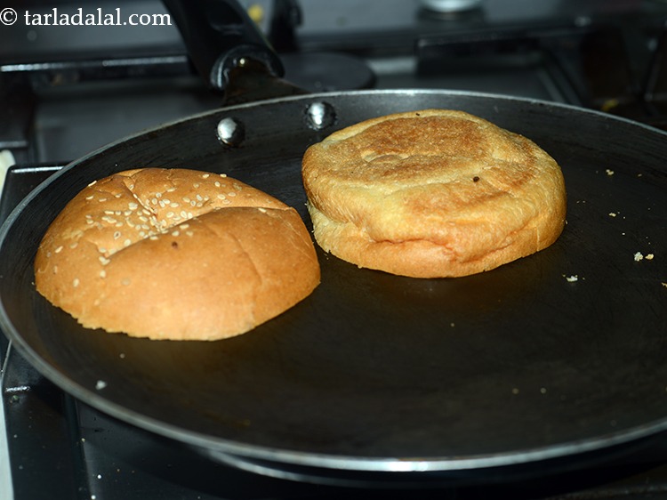 Step 31 – Place the burger bun on a tava (griddle) and toast them lightly.
