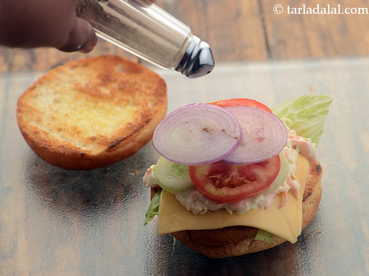 Step 41 – Sprinkle a little salt and pepper evenly over the <strong>veg burgers</strong>.