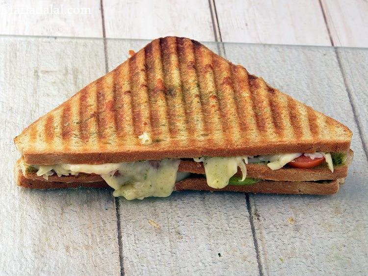 Step 19 – Remove the <strong>vegetable cheese grilled sandwich</strong> and place on a chopping board.