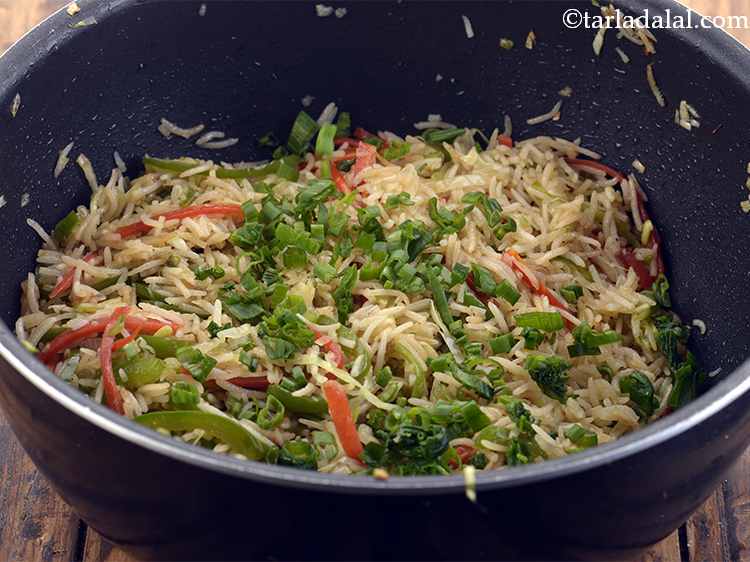 Step 29 – Add the spring onion greens to the&nbsp;<strong>Chinese vegetable fried rice</strong>, mix well and cook on …