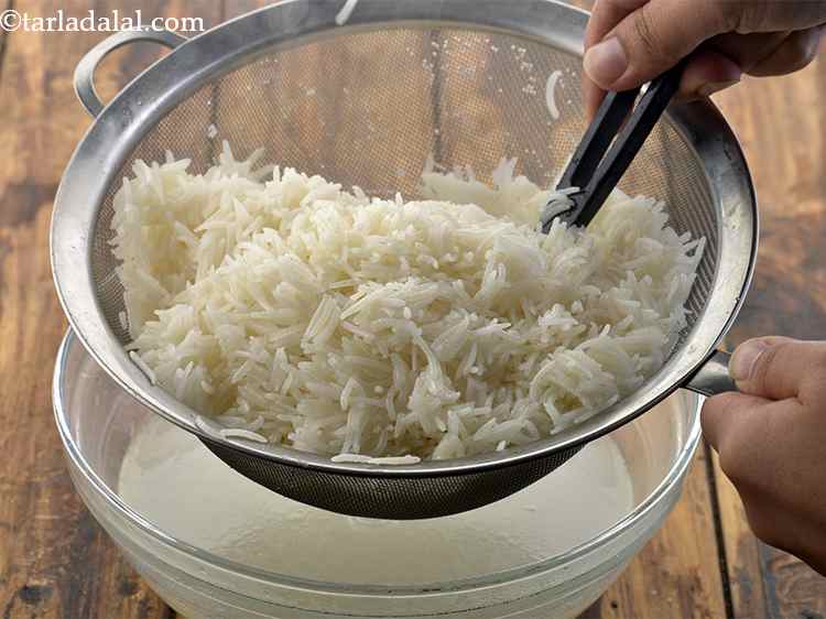 Step 12 – Toss the rice in it. Ensure each grain is coated well with oil.