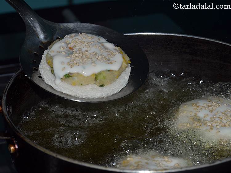Step 24 – Heat the oil in a deep non-stick pan and add 3 gold coins at a …