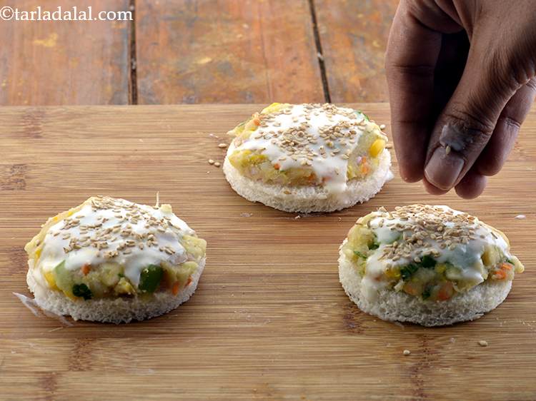 Step 22 – Sprinkle a little sesame seeds over the plain flour-water mixture.