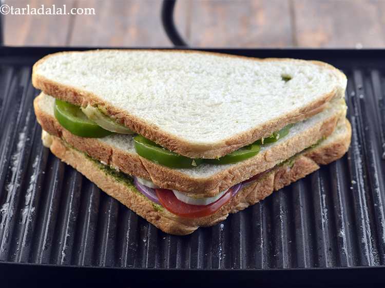 Step 16 – Press it lightly. Place the prepared&nbsp;<strong>vegetable sandwich</strong>&nbsp;in a greased and pre-heated sandwich griller. By turning …