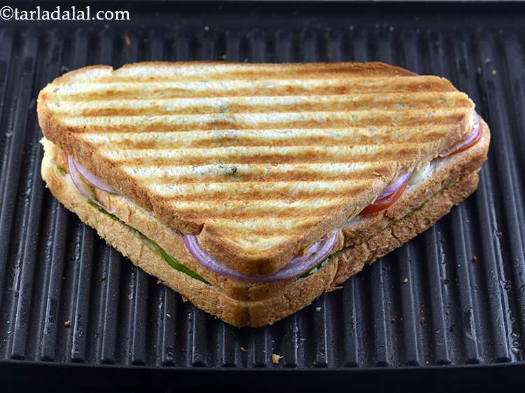 Step 18 – Grill it for 3 to 4 minutes or till the&nbsp;<strong>Vegetable Grilled Sandwich</strong>&nbsp;turns golden brown in …