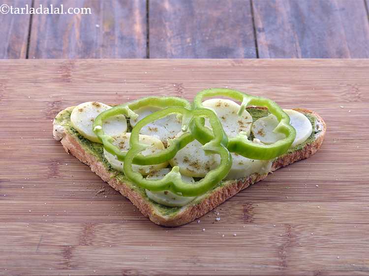 Step 7 – Arrange 3 capsicum rings evenly over it. Make sure you do not cut the rings …