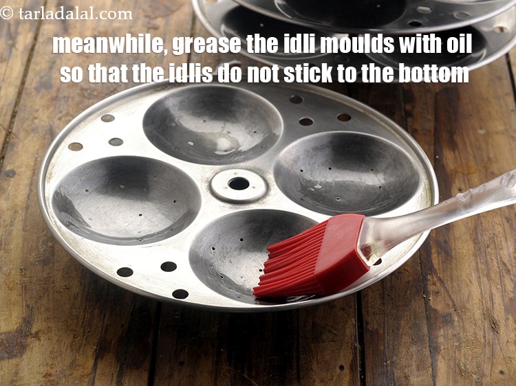 Step 24 – <meta charset="UTF-8" /> Meanwhile, grease the idli moulds with oil so that the idlis do …