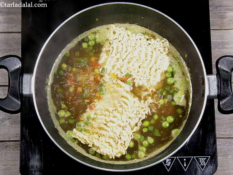 Step 7 – Once the water is rapidly boiling, add the maggi noodles.