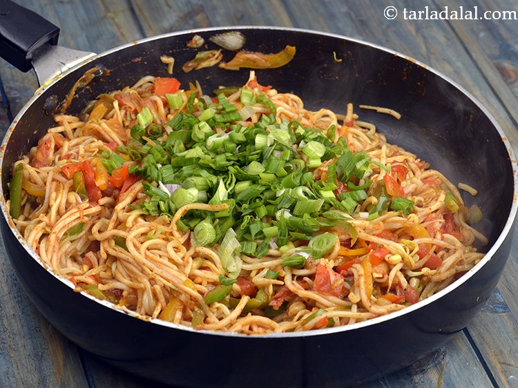 Step 21 – Switch of the flame and add the spring onion greens. These should not be over …