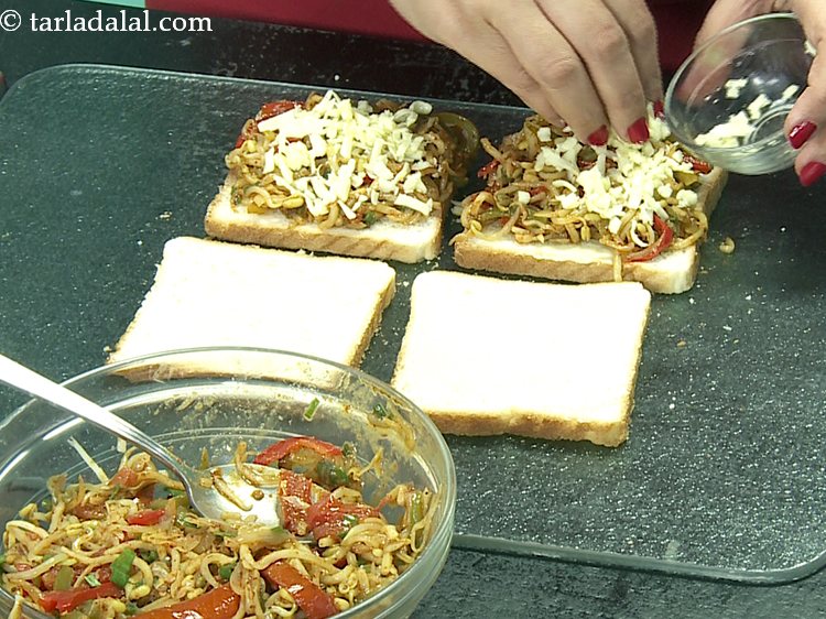 Step 27 – Sprinkle 1 tbsp of cheese evenly over each cheesey masala noodle sandwich.